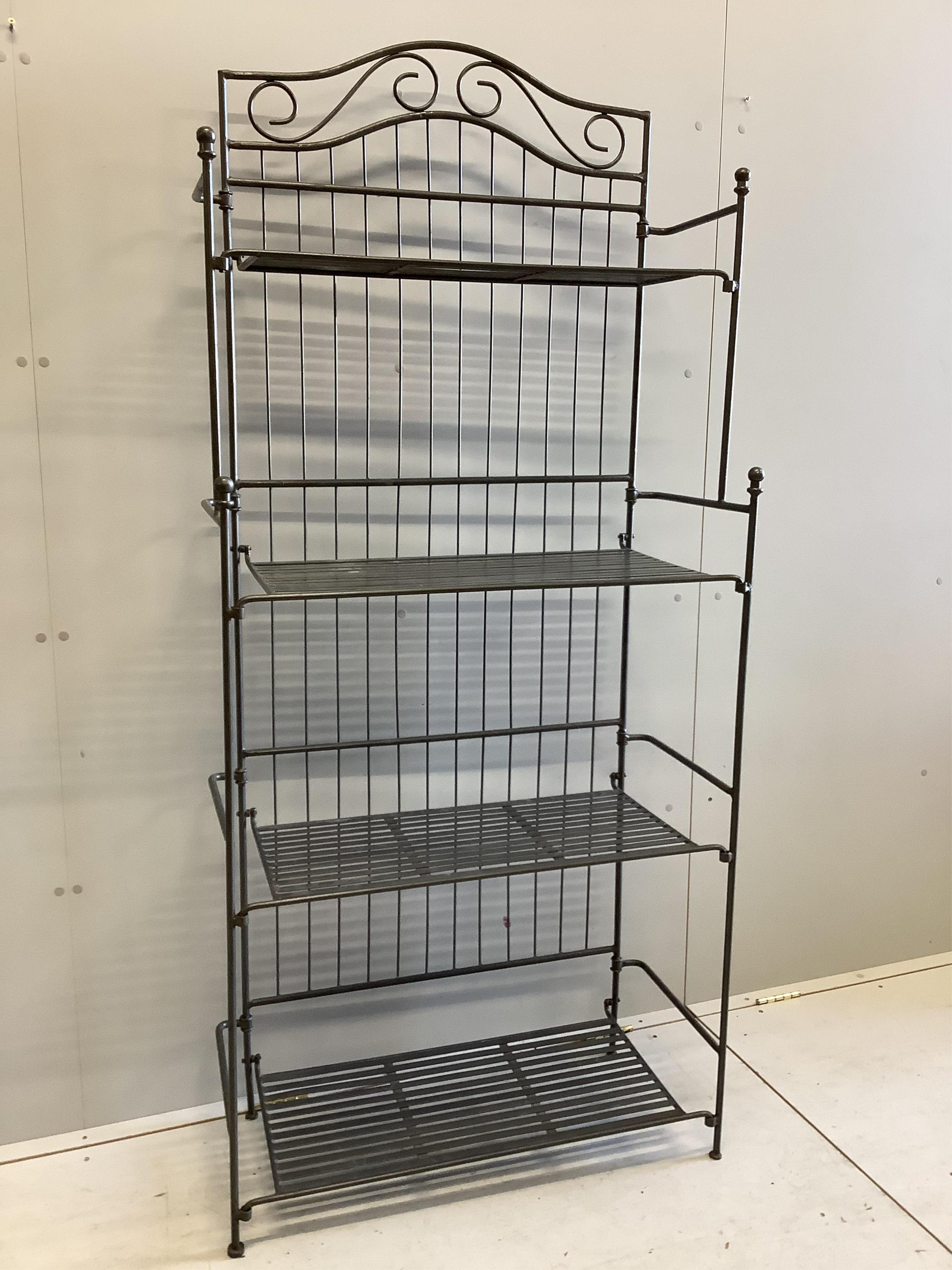 A modern wrought iron four tier baker's rack, width 82cm, height 186cm. Condition - good